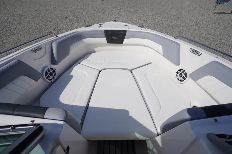 Slide: The Image of 2022 Chaparral 23 SSi OB boat interior with white cushioned seating. - 2