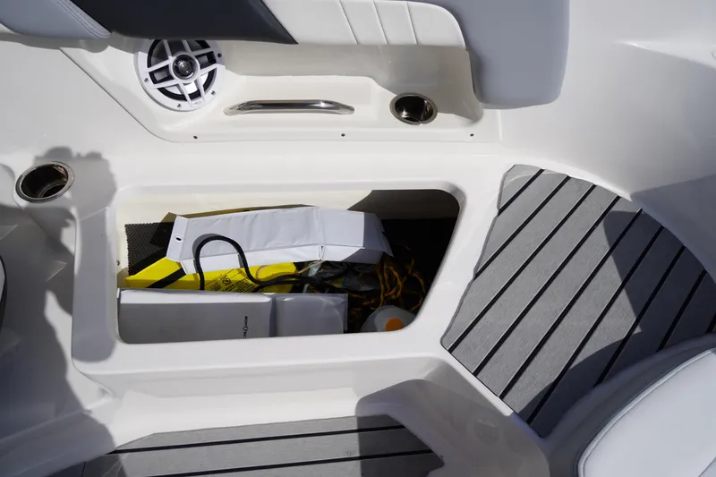Slide: The Image of 2022 Chaparral 23 SSi OB boat storage compartment with speaker and accessories. - 30
