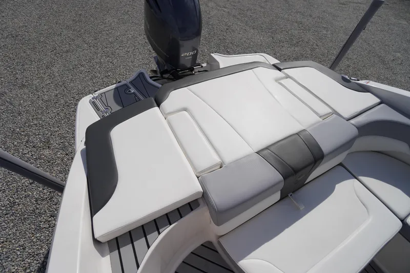 Slide: The Image of 2022 Chaparral 23 SSi OB boat with sleek white seating and powerful outboard motor. - 33