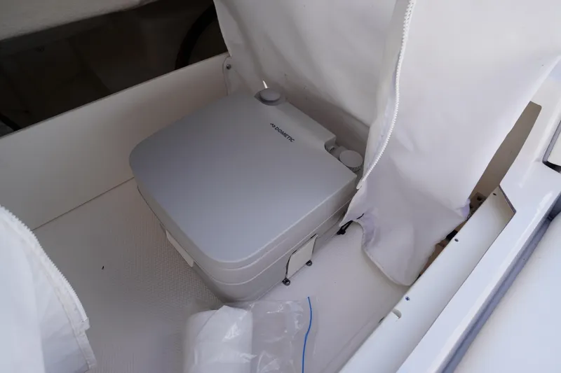 Slide: The Image of Portable toilet in 2022 Chaparral 23 SSi OB boat interior compartment. - 37