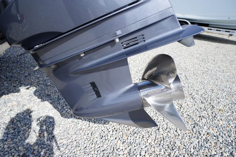 Slide: The Image of 2022 Chaparral 23 SSi OB boat propeller on gravel surface. - 43