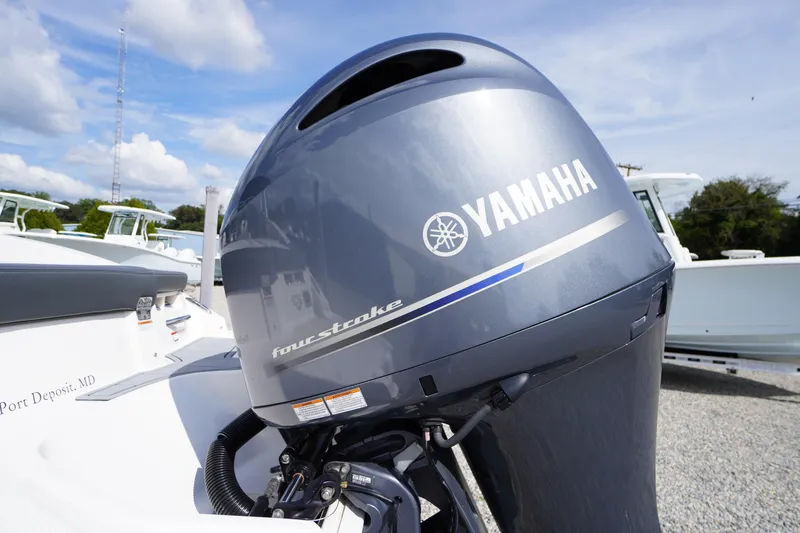 Slide: The Image of 2022 Chaparral 23 SSi OB with Yamaha four-stroke outboard motor, parked outdoors. - 45