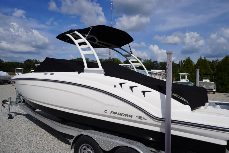 Slide: The Image of 2022 Chaparral 23 SSi OB boat on trailer, covered, under blue sky. - 47