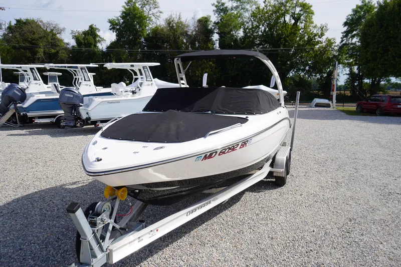 Slide: The Image of 2022 Chaparral 23 SSi OB boat on trailer, covered, in outdoor lot. - 48