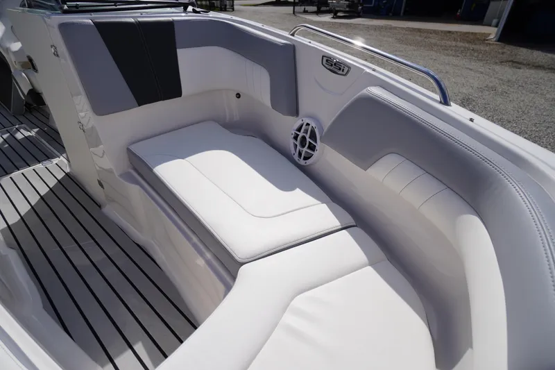 Slide: The Image of 2022 Chaparral 23 SSi OB boat interior with white seating and speaker. - 5
