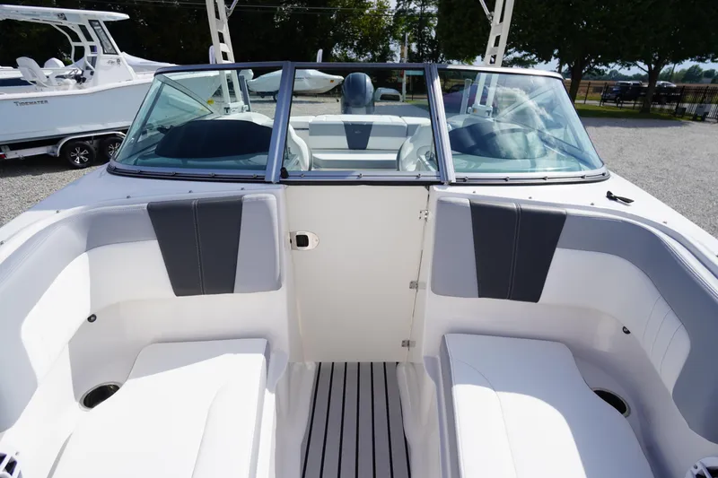 Slide: The Image of 2022 Chaparral 23 SSi OB boat interior with white seating and windshield. - 6
