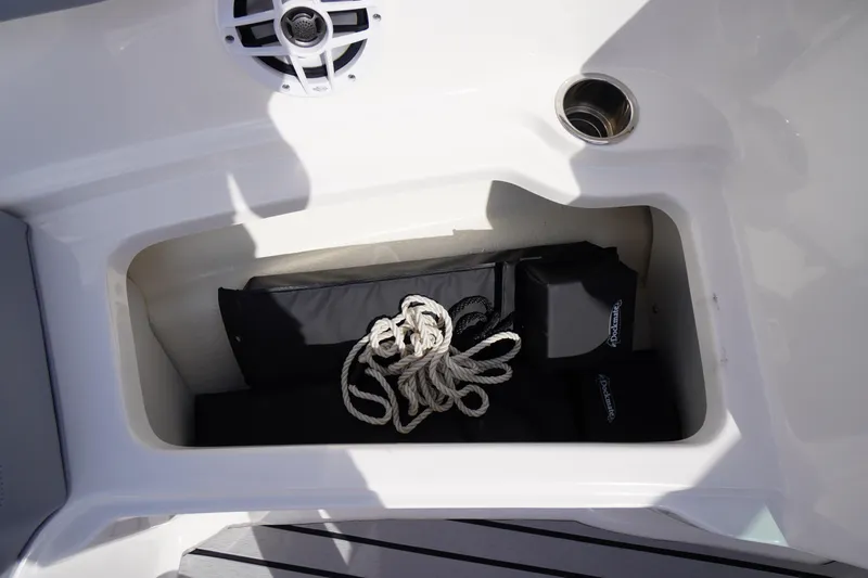Slide: The Image of Storage compartment in 2022 Chaparral 23 SSi OB boat with rope and accessories. - 8
