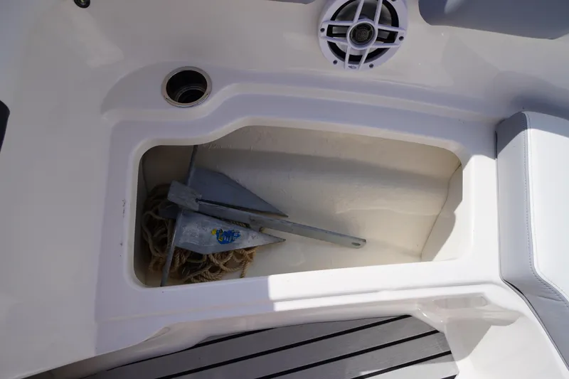 Slide: The Image of Storage compartment with anchor and rope on 2022 Chaparral 23 SSi OB boat. - 9