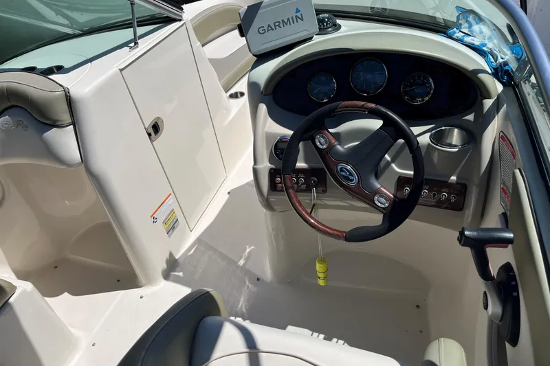 Slide: The Image of 2006 Sea Ray 200 Sundeck boat interior with steering wheel and Garmin navigation system. - 4