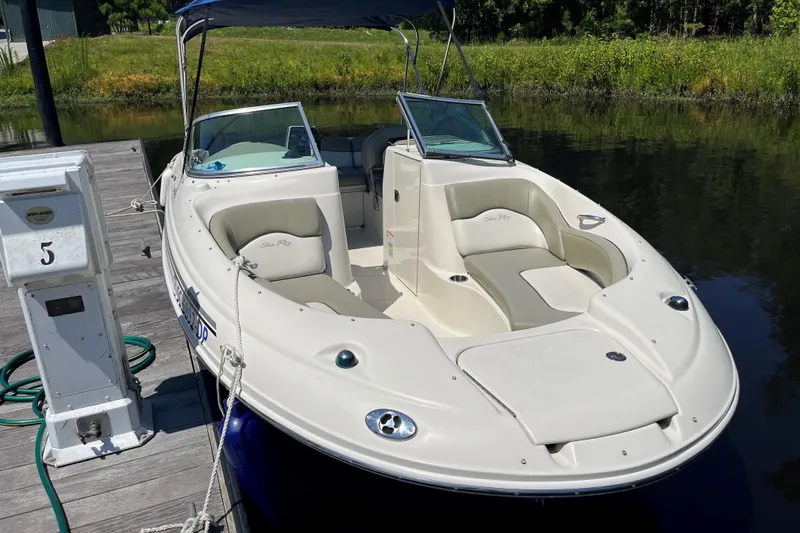 Slide: The Image of 2006 Sea Ray 200 Sundeck boat docked, featuring spacious seating and sleek design. - 5