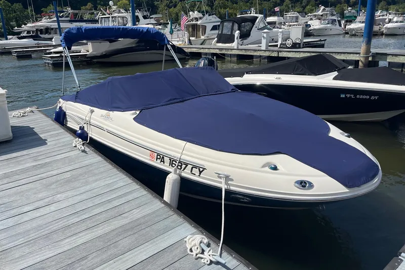 Slide: The Image of 2006 Sea Ray 200 Sundeck boat docked with blue cover in marina. - 6