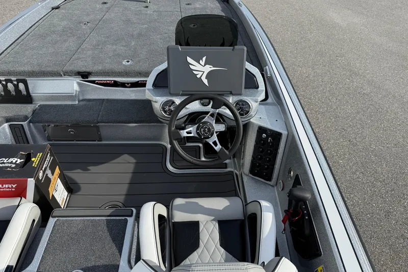 Slide: The Image of 2026 Phoenix 920 Elite X boat interior with steering wheel and control panel. - 13