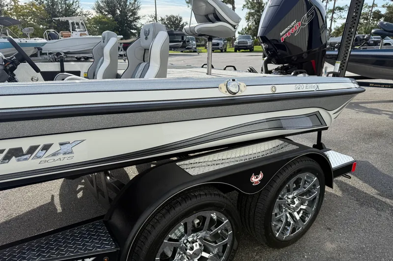 Slide: The Image of 2026 Phoenix 920 Elite X boat with dual wheels and Mercury Pro XS engine. - 3