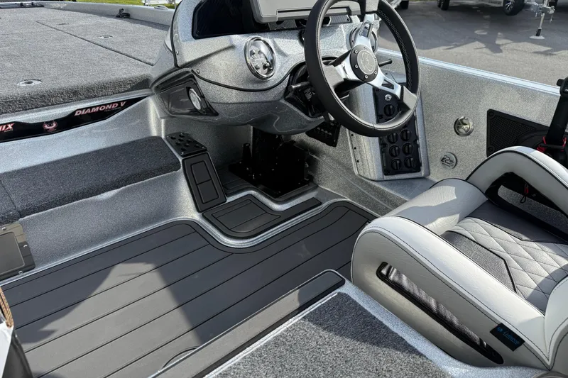 Slide: The Image of 2026 Phoenix 920 Elite X boat interior with modern steering and seating. - 5
