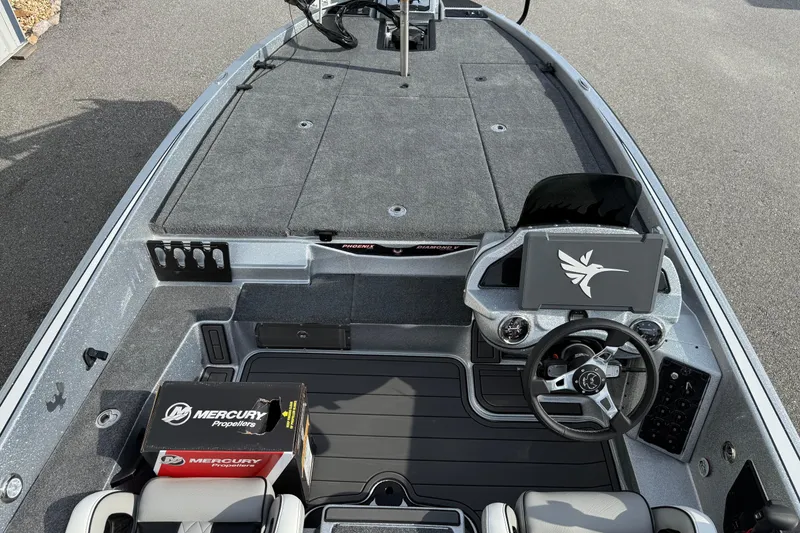 Slide: The Image of Phoenix 920 Elite X 2026 boat interior with steering wheel and Mercury Propellers box. - 7