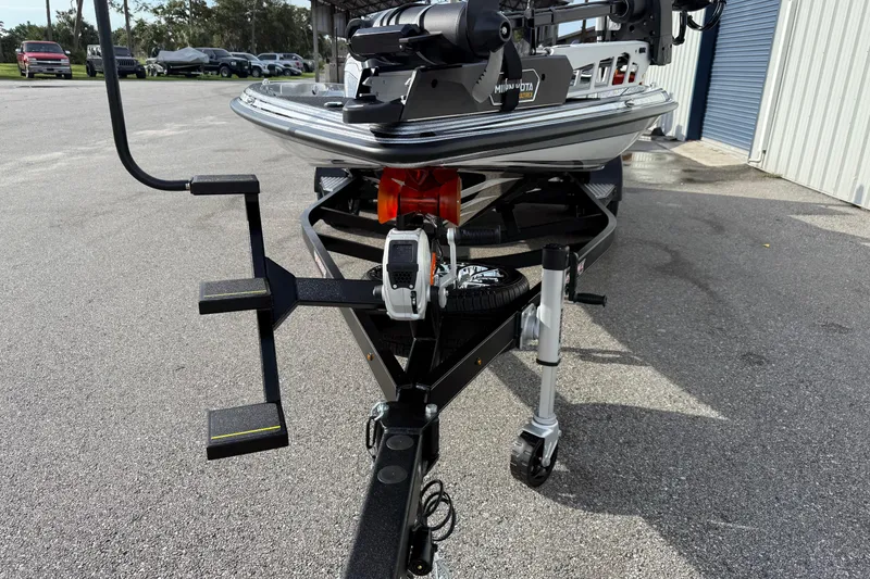Slide: The Image of Front view of 2026 Phoenix 920 Elite X boat on trailer in parking lot. - 8