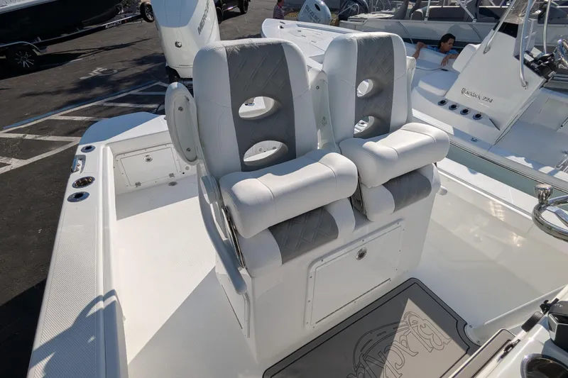 Slide: The Image of 2026 BlackJack 256 Coastal boat with T-top and seating, displayed at a marina. - 8