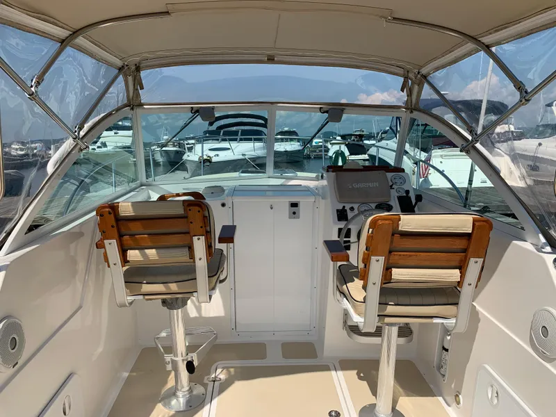 Slide: The Image of 2004 Hunt Yachts Surfhunter 25 cockpit with dual wooden seats and clear canopy. - 12