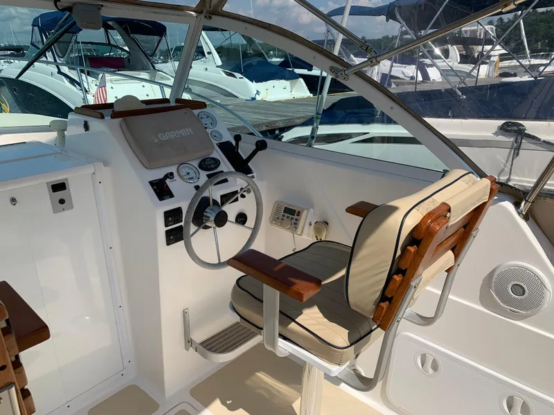 Slide: The Image of 2004 Hunt Yachts Surfhunter 25 helm with classic wooden accents and modern navigation equipment. - 14