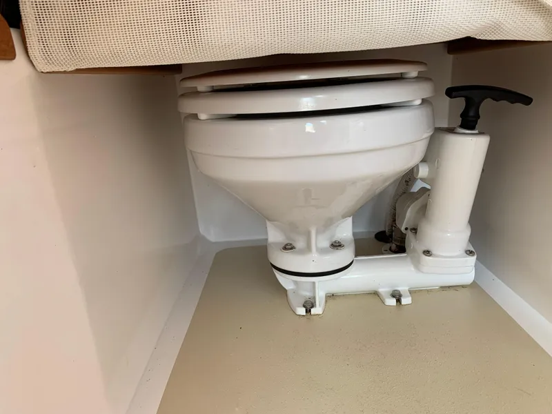 Slide: The Image of 2004 Hunt Yachts Surfhunter 25 marine toilet with manual pump handle. - 18