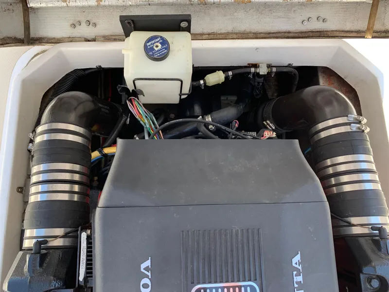 Slide: The Image of Engine compartment of a 2004 Hunt Yachts Surfhunter 25, featuring a Volvo Penta engine. - 25