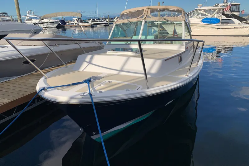 Slide: The Image of 2004 Hunt Yachts Surfhunter 25 docked in a marina, surrounded by other boats. - 31