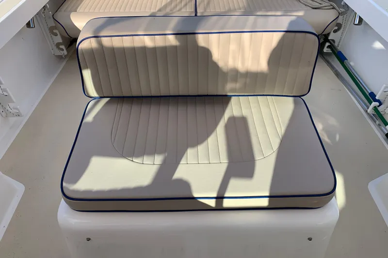 Slide: The Image of 2004 Hunt Yachts Surfhunter 25 interior seating with beige cushions and blue piping. - 40