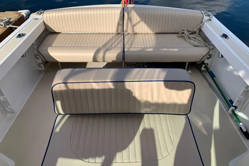 Slide: The Image of 2004 Hunt Yachts Surfhunter 25 interior with beige cushioned seating and nautical details. - 41