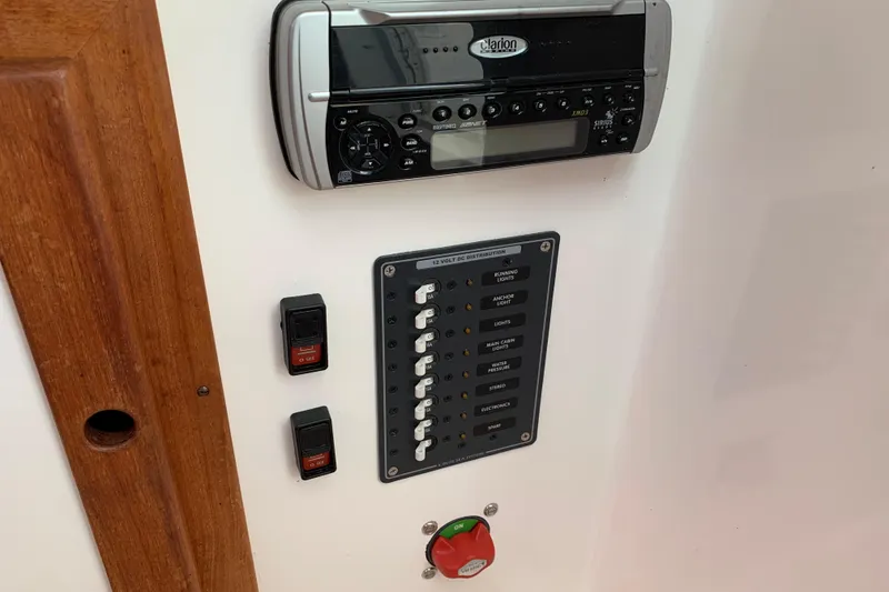 Slide: The Image of 2004 Hunt Yachts Surfhunter 25 control panel with stereo and switches. - 50