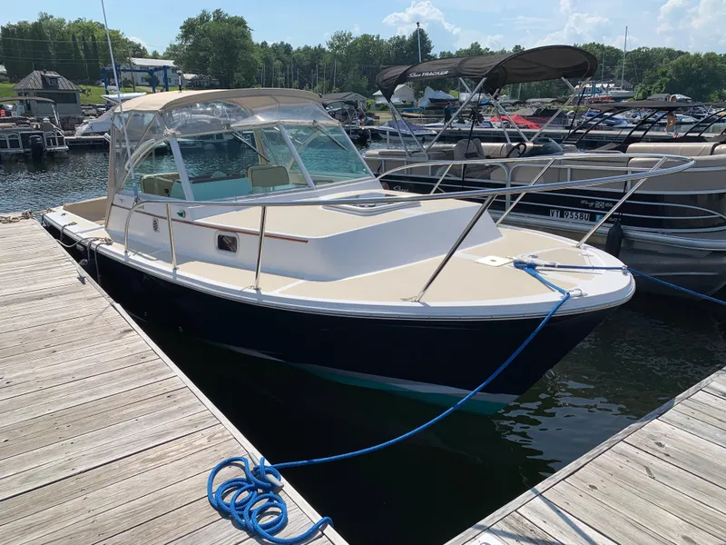 Slide: The Image of 2004 Hunt Yachts Surfhunter 25 docked at marina, sunny day, calm waters. - 6