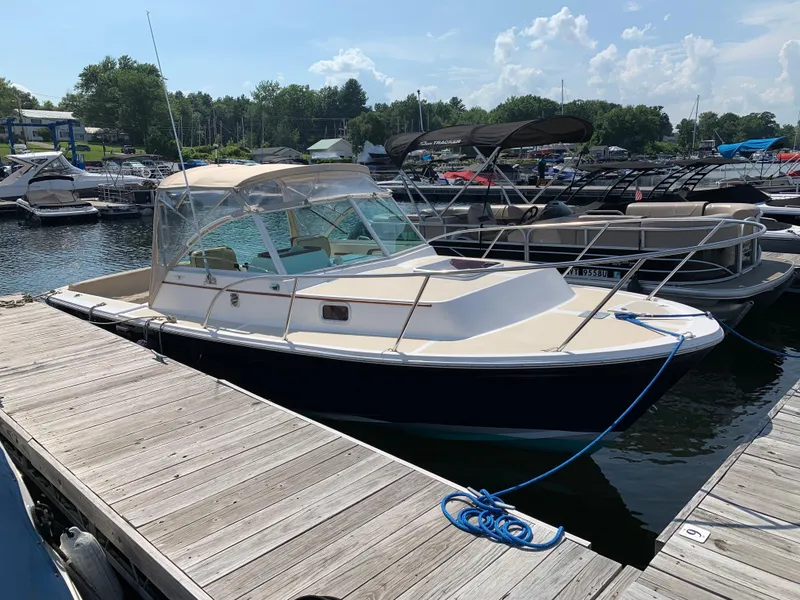 Slide: The Image of 2004 Hunt Yachts Surfhunter 25 docked at a marina on a sunny day. - 8