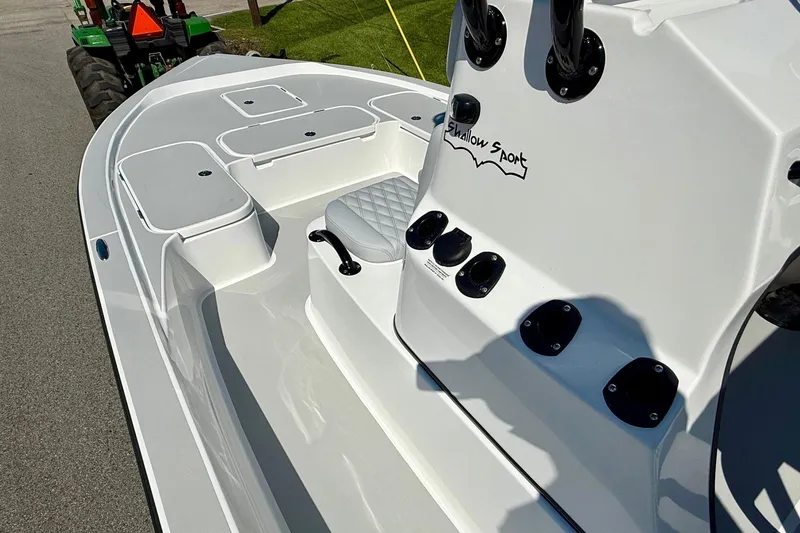 Slide: The Image of 2026 Shallow Sport 24 Modified V boat interior with seating and storage compartments. - 12