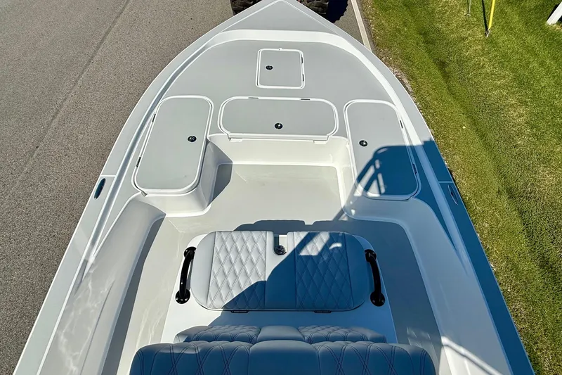 Slide: The Image of 2026 Shallow Sport 24 Modified V boat interior with seating and storage compartments. - 13