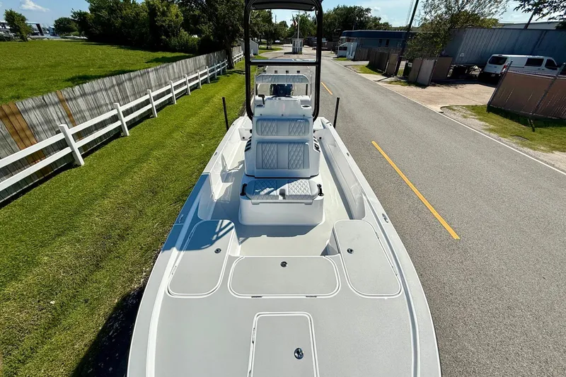 Slide: The Image of 2026 Shallow Sport 24 Modified V boat on a road, showcasing sleek design and spacious deck. - 15