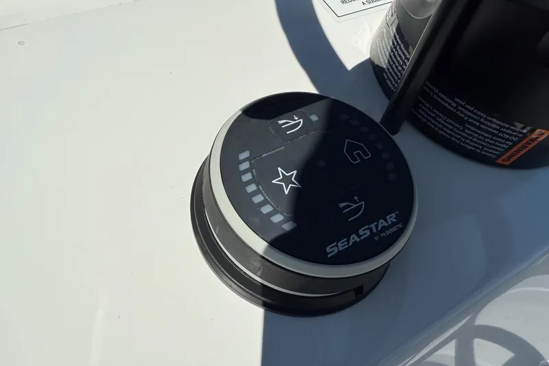 Slide: The Image of SeaStar control panel on 2026 Shallow Sport 24 Modified V boat, featuring navigation symbols. - 16