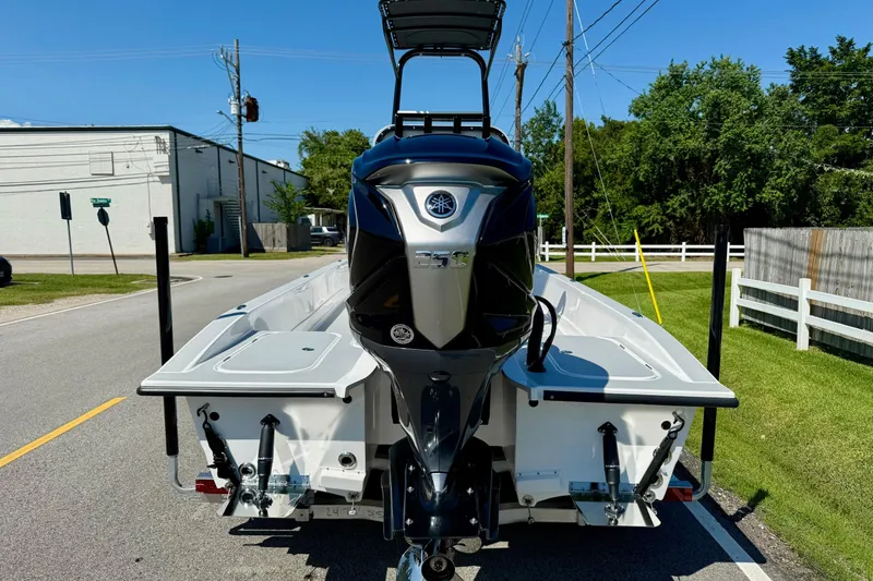 Slide: The Image of 2026 Shallow Sport 24 Modified V boat with Yamaha outboard motor on a sunny street. - 3