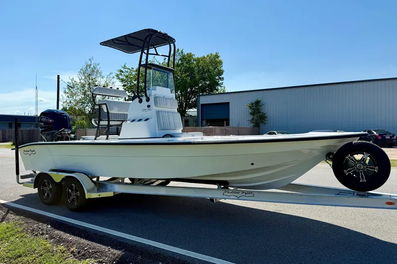 Slide: The Image of 2026 Shallow Sport 24 Modified V boat on trailer, parked outdoors. - 5