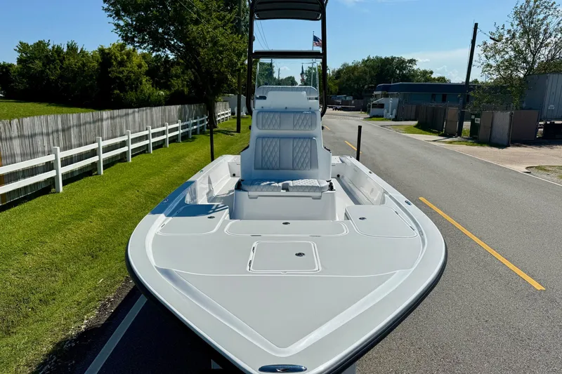 Slide: The Image of 2026 Shallow Sport 24 Modified V boat on a road, sunny day. - 6
