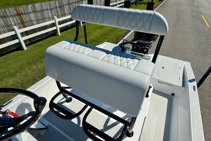 Slide: The Image of 2026 Shallow Sport 24 Modified V boat with white cushioned seating and sleek design. - 9