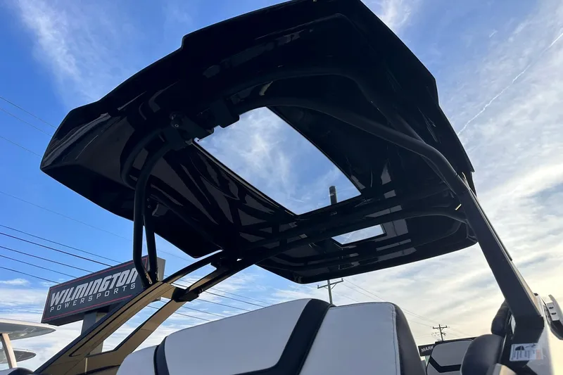 Slide: The Image of 2025 Yamaha Boats 275SD with sleek black canopy against blue sky. - 10