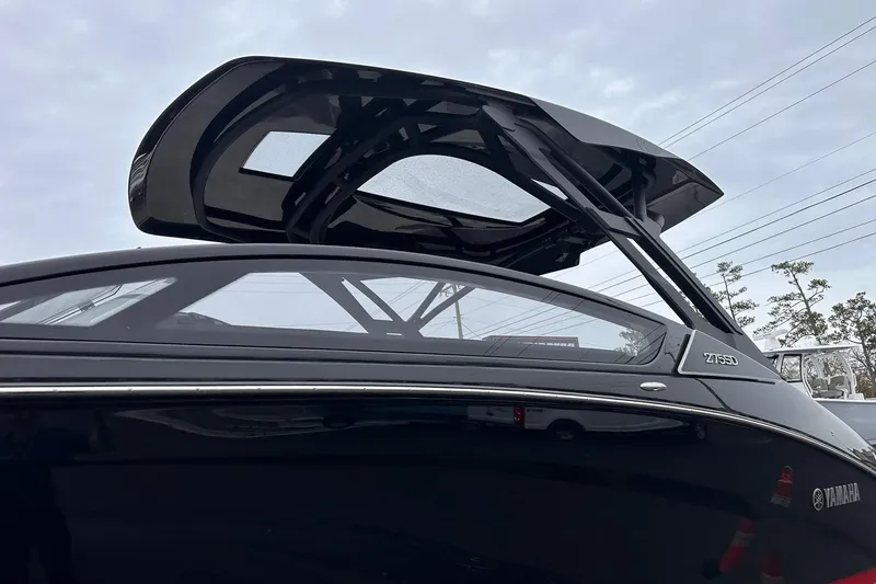 Slide: The Image of 2025 Yamaha Boats 275SD with sleek black design and modern canopy. - 14