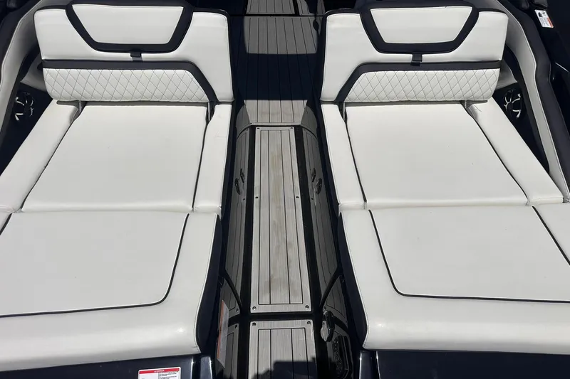 Slide: The Image of 2025 Yamaha Boats 275SD interior with white cushioned seating and sleek design. - 16