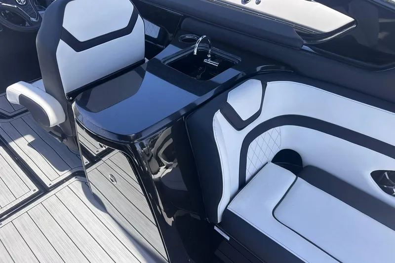 Slide: The Image of 2025 Yamaha Boats 275SD interior with sleek black and white seating and modern design. - 21