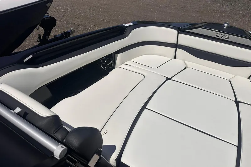 Slide: The Image of 2025 Yamaha Boats 275SD interior with sleek white seating and modern design. - 37