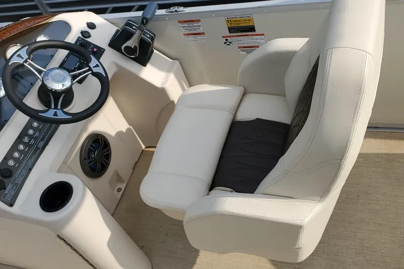Slide: The Image of Captain's seat and helm of 2023 Lexington 318s boat, featuring steering wheel and controls. - 5