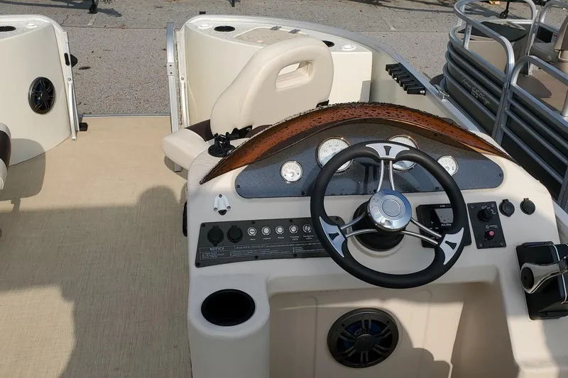 Slide: The Image of 2023 Lexington 318s boat dashboard with steering wheel and control panel. - 6