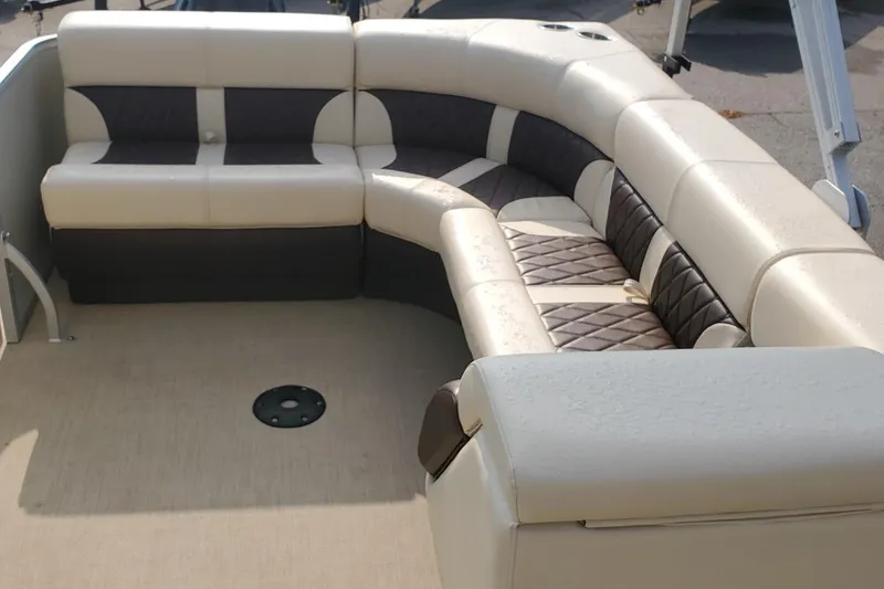 Slide: The Image of Luxurious seating on 2023 Lexington 318s boat, featuring beige and brown upholstery. - 7