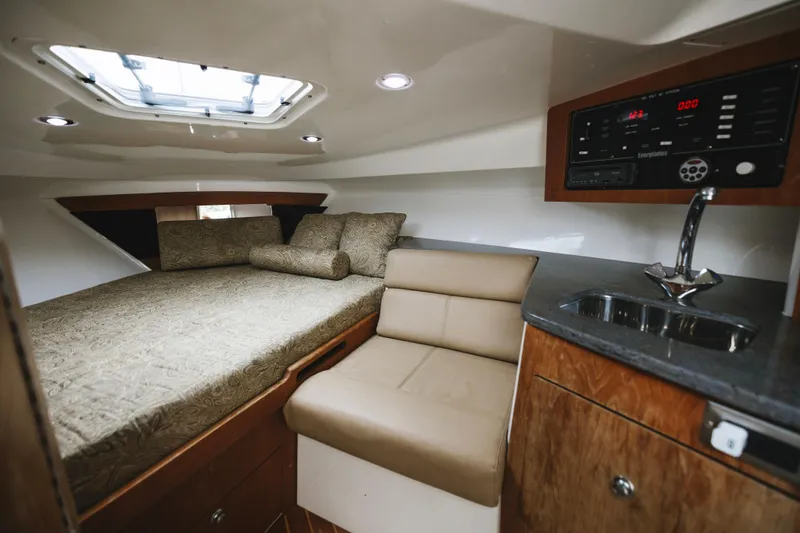 Slide: The Image of Luxurious 2008 Everglades 350LX cabin interior with bed, seating, and kitchenette. - 12