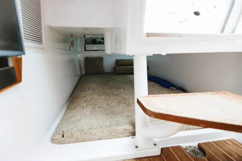 Slide: The Image of Interior cabin of 2008 Everglades 350LX boat with cushioned sleeping area. - 14