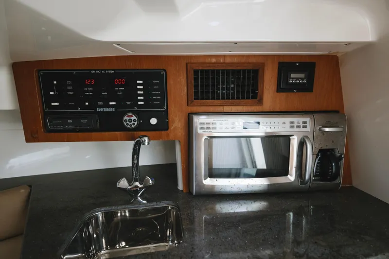 Slide: The Image of Interior of 2008 Everglades 350LX boat with control panel, sink, and microwave. - 15